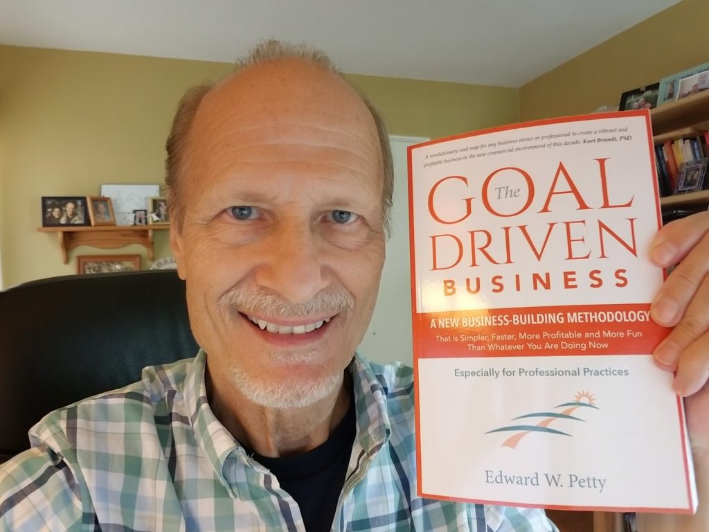 Edward Petty displaying his new book, The Goal Driven Business