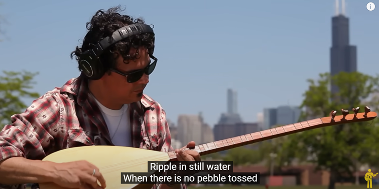 guitar player overlooking a city. 